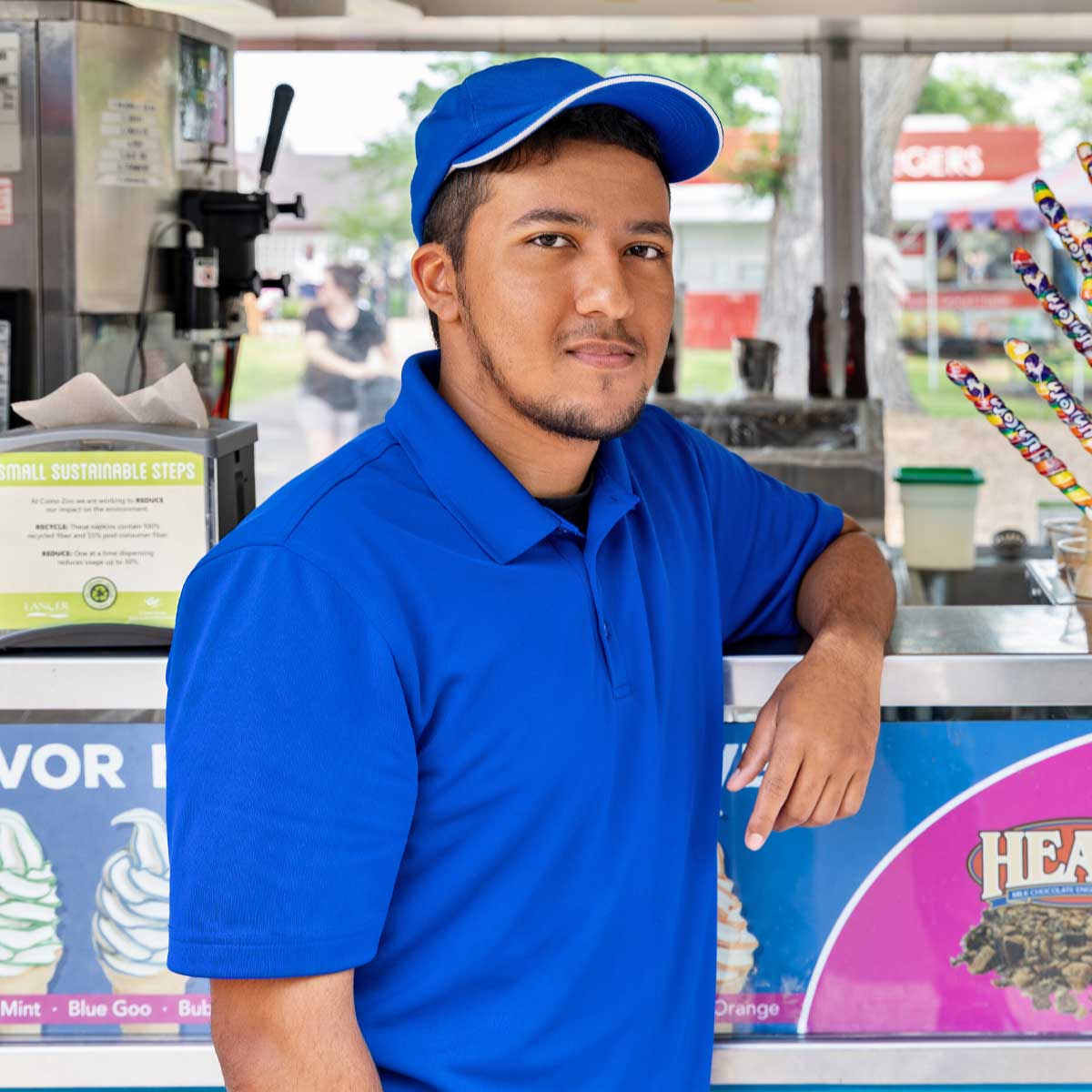 Employee standing next to mobile food cart